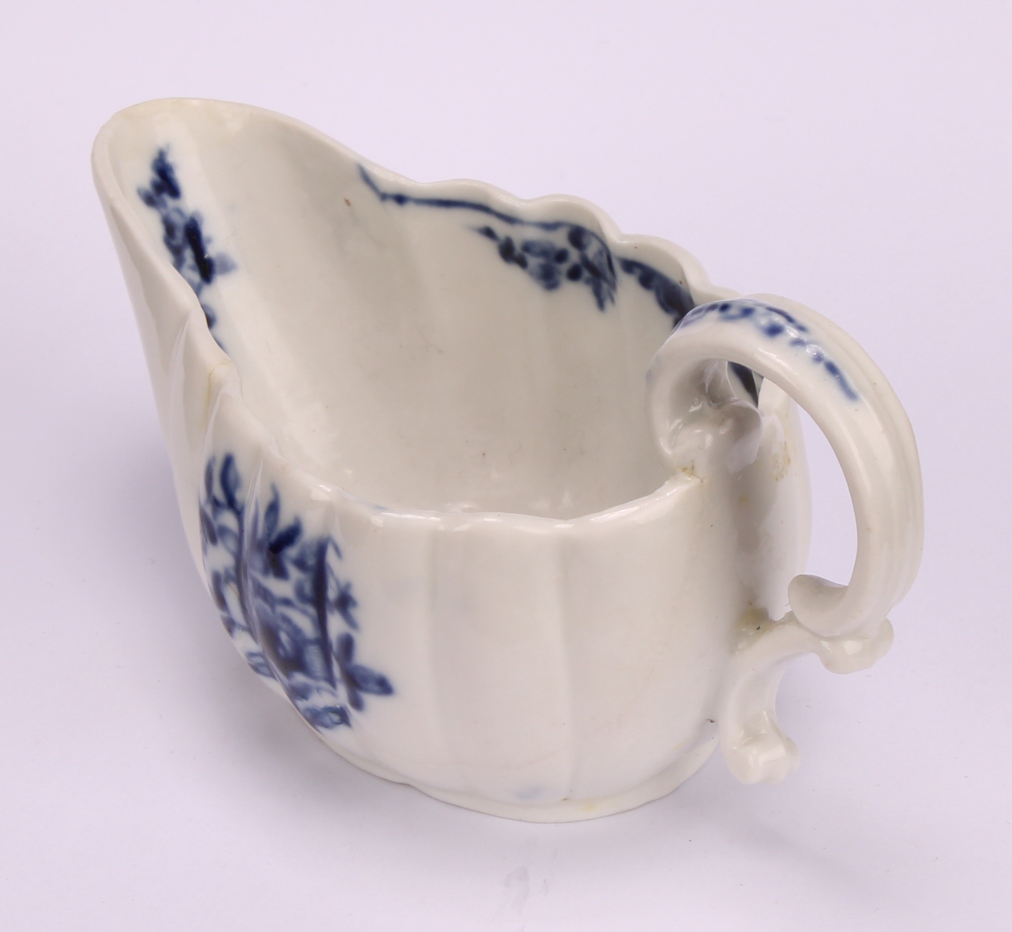 A Cookworthy Bristol butter boat, of fluted form, painted in underglaze blue with flowers, 11cm - Image 4 of 5