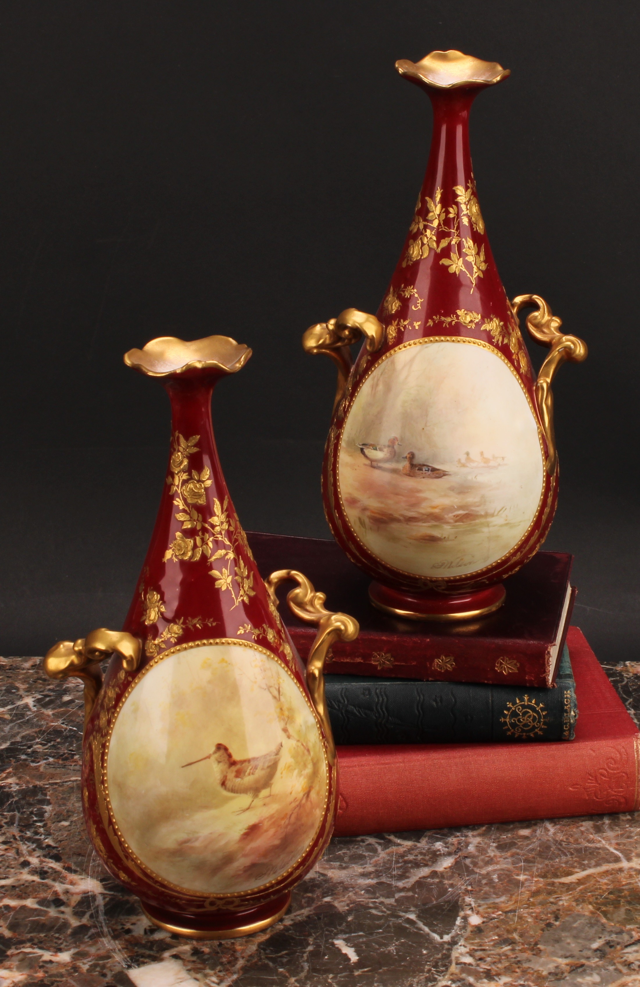 A pair of Doulton Burslem two handled pedestal bottle vases, painted by S. Wilson, signed, with