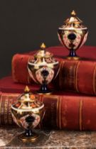 An associated pair of Royal Crown Derby 1128 Imari pattern ovoid pedestal vases, domed covers,