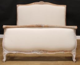 A Louis XV Revival bed, stuffed-over head and footboard, the headboard 131.5cm high, the internal