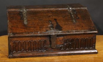 An 18th century oak boarded table box, hinged sloping top above a nulled frieze, 29cm high, 63.5cm