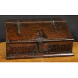 An 18th century oak boarded table box, hinged sloping top above a nulled frieze, 29cm high, 63.5cm