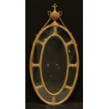 A 19th century Neo-Classical softwood and gesso oval looking glass, the mirror plate crested by an