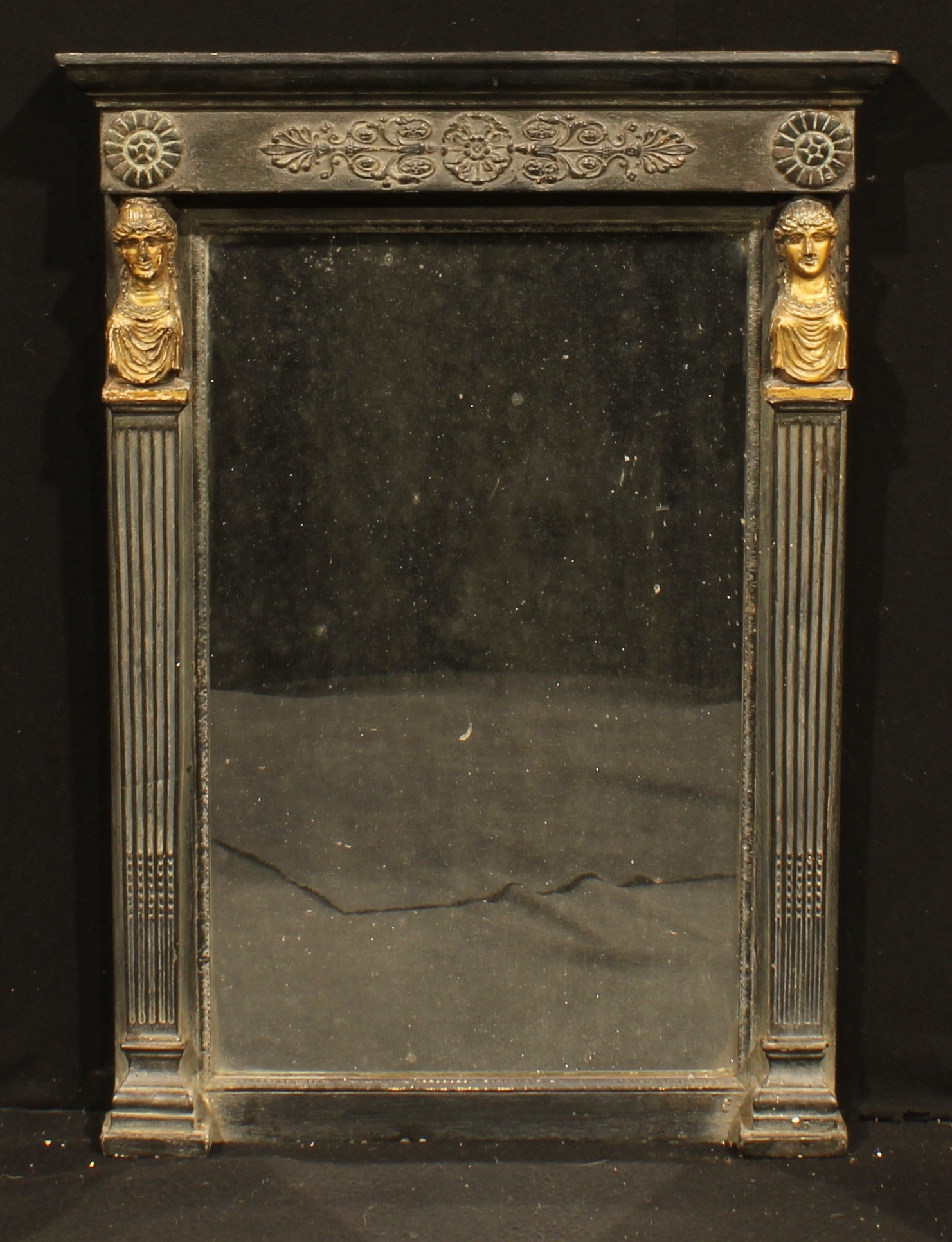 A 19th century parcel-gilt ebonised looking glass, rectangular mirror plate, flanked by female