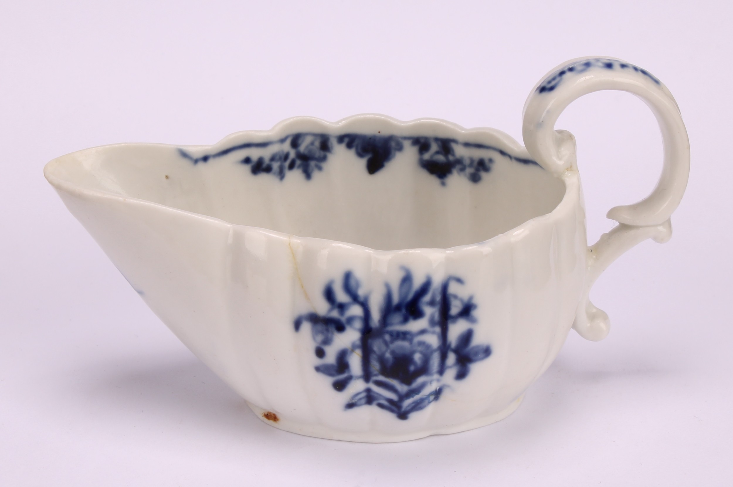 A Cookworthy Bristol butter boat, of fluted form, painted in underglaze blue with flowers, 11cm - Image 2 of 5