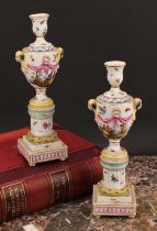 A pair of Berlin porcelain cassolettes, each as a pedestal urn on column support, stepped square