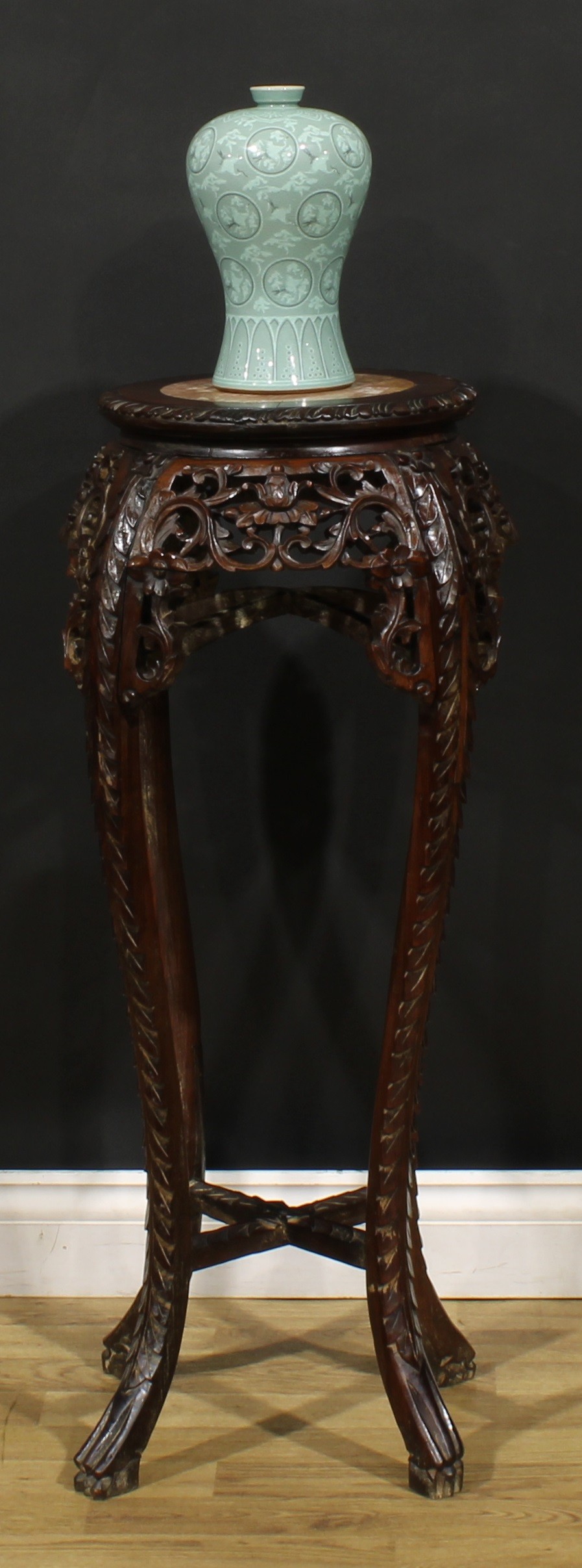 A Chinese hardwood jardiniere stand, circular top with foliate carved edge and inset marble panel,