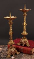 A pair of Historicist gilt metal and painted pricket candlesticks, cast in the medieval taste, the