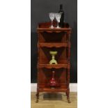 A late Victorian walnut four-tier whatnot, shaped three-quarter gallery, ring-turned supports,