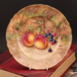An English porcelain shaped circular plate, painted by Frank Higgins, signed, previously a painter