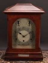 An early 20th century oak musical bracket clock, 17cm arched silvered dial inscribed with Arabic