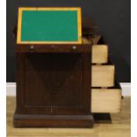 A late 19th century oak single pedestal desk, hinged top enclosing a baize surface above a long