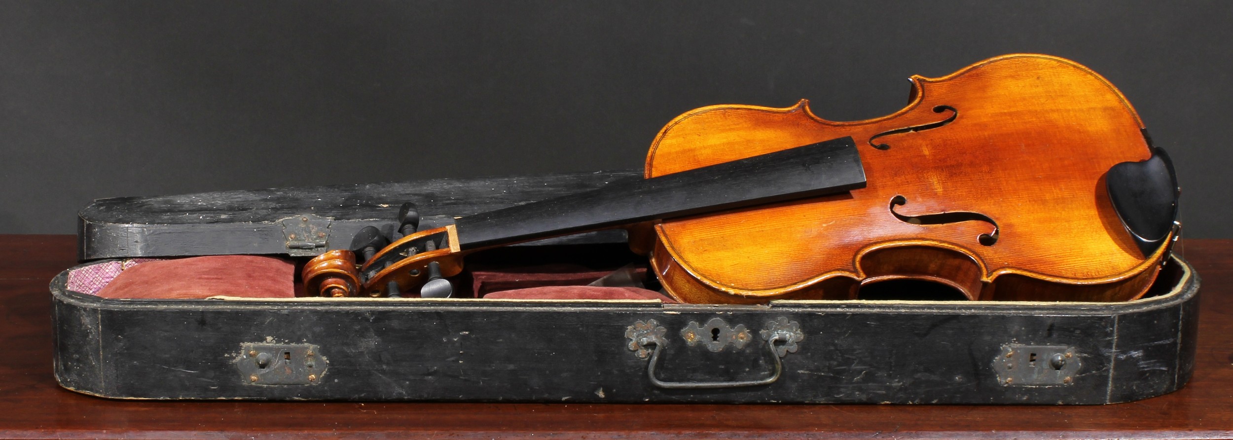 A violin, the one-piece back 36cm long excluding button, ebonised tuning pegs, outlined with
