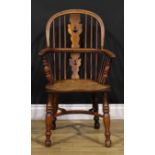 A 19th century yew and elm child’s Windsor elbow chair, low hooped back, shaped and pierced splat,