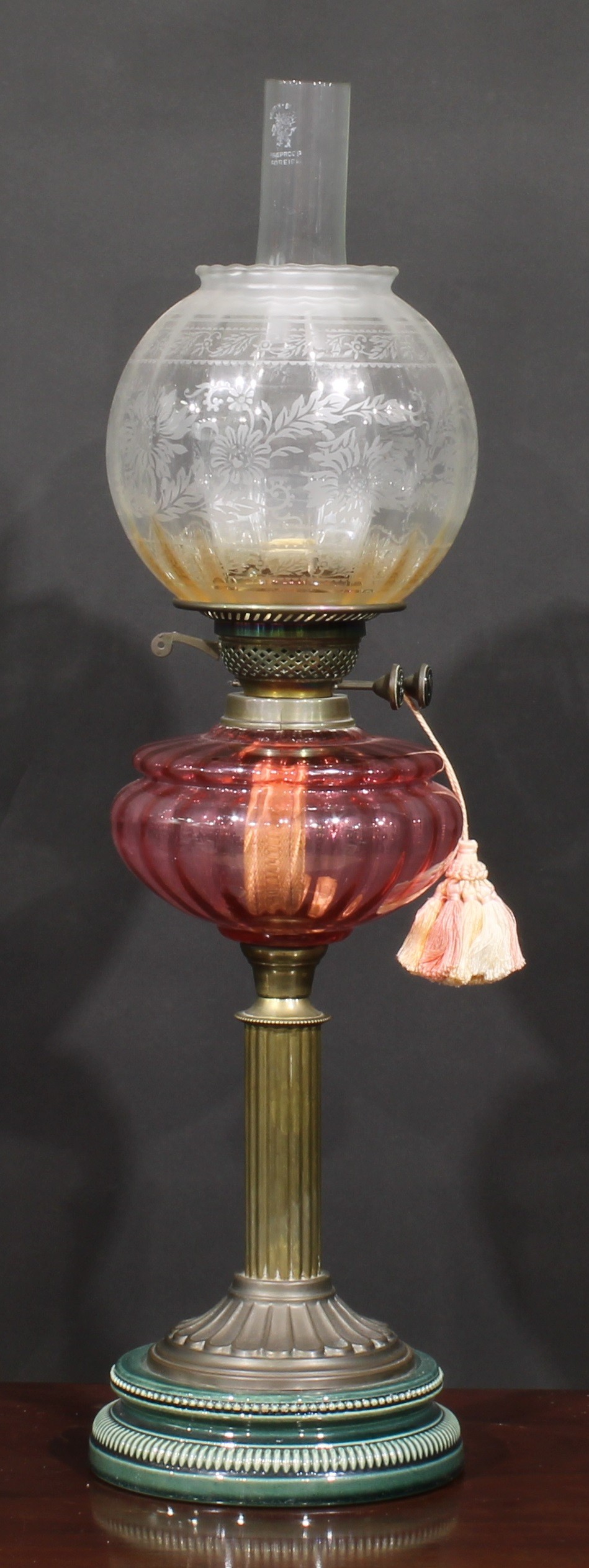 A late Victorian/Edwardian oil lamp, Duplex burner, facetted cranberry glass font, brass column - Image 2 of 3