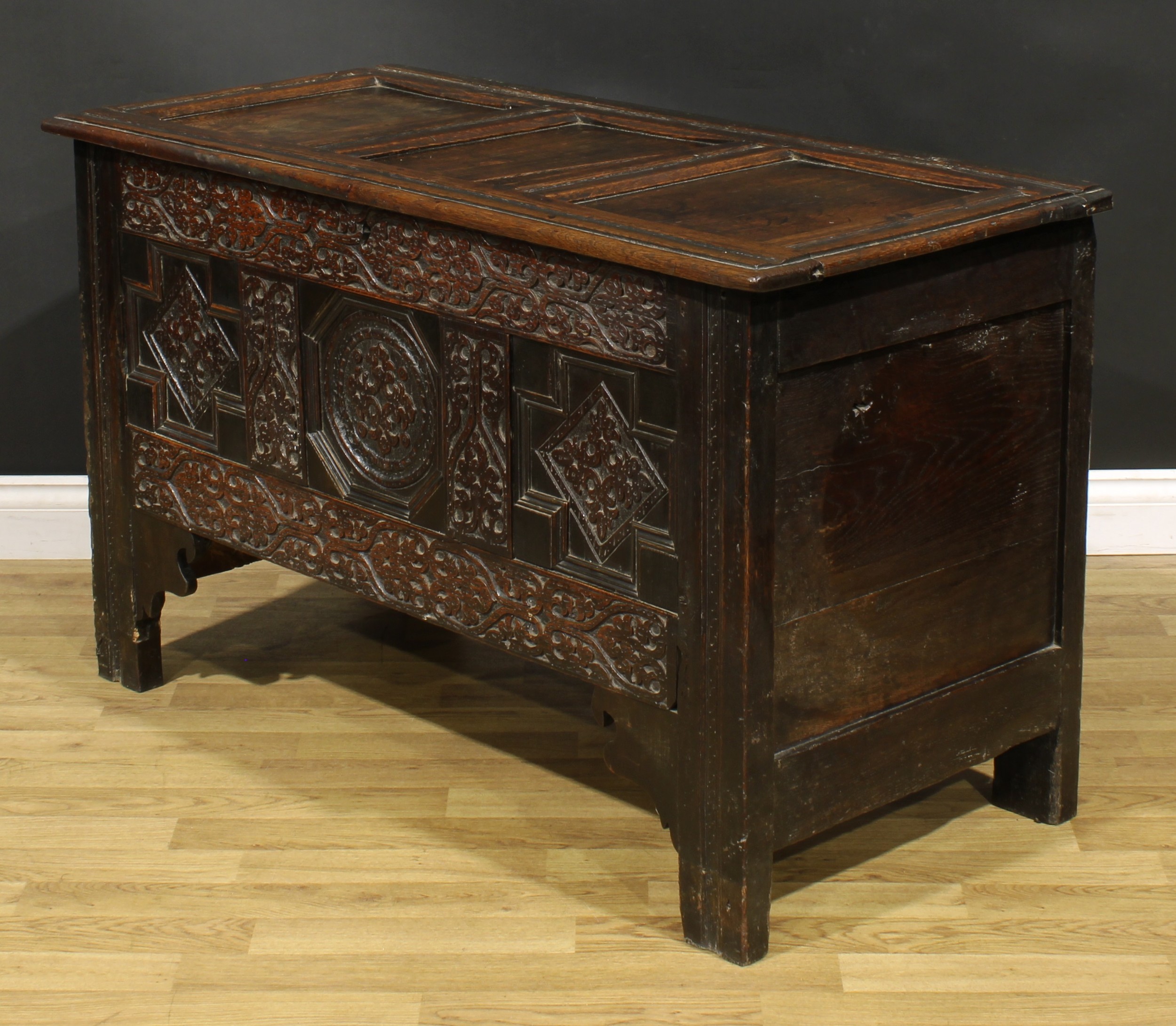 A Charles II oak three panel blanket chest, hinged top, the front profusely carved with leafy - Image 4 of 5