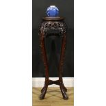 A Chinese hardwood jardiniere stand, circular top with beaded border and inset marble panel,