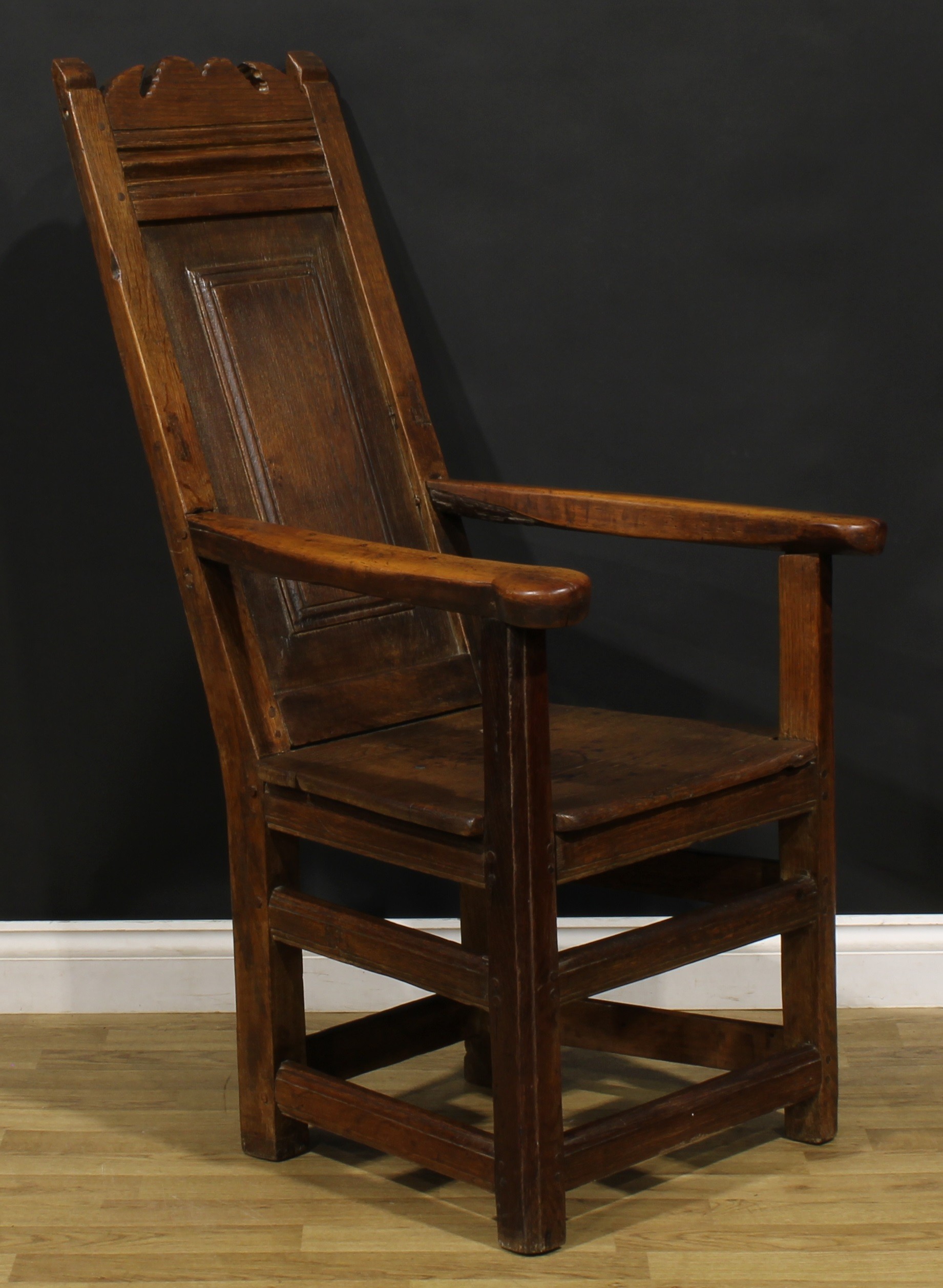 An 18th century and later oak and fruitwood caquetoire or panel-back armchair, possibly Scottish, - Image 2 of 4