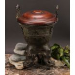A Chinese patinated bronze ding censer, cast in the archaic manner, twist handles, outswept rim,