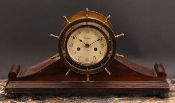 An early 20th century brass and mahogany ship’s wheel mantel clock, 10.5cm silvered dial inscribed