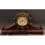 An early 20th century brass and mahogany ship’s wheel mantel clock, 10.5cm silvered dial inscribed