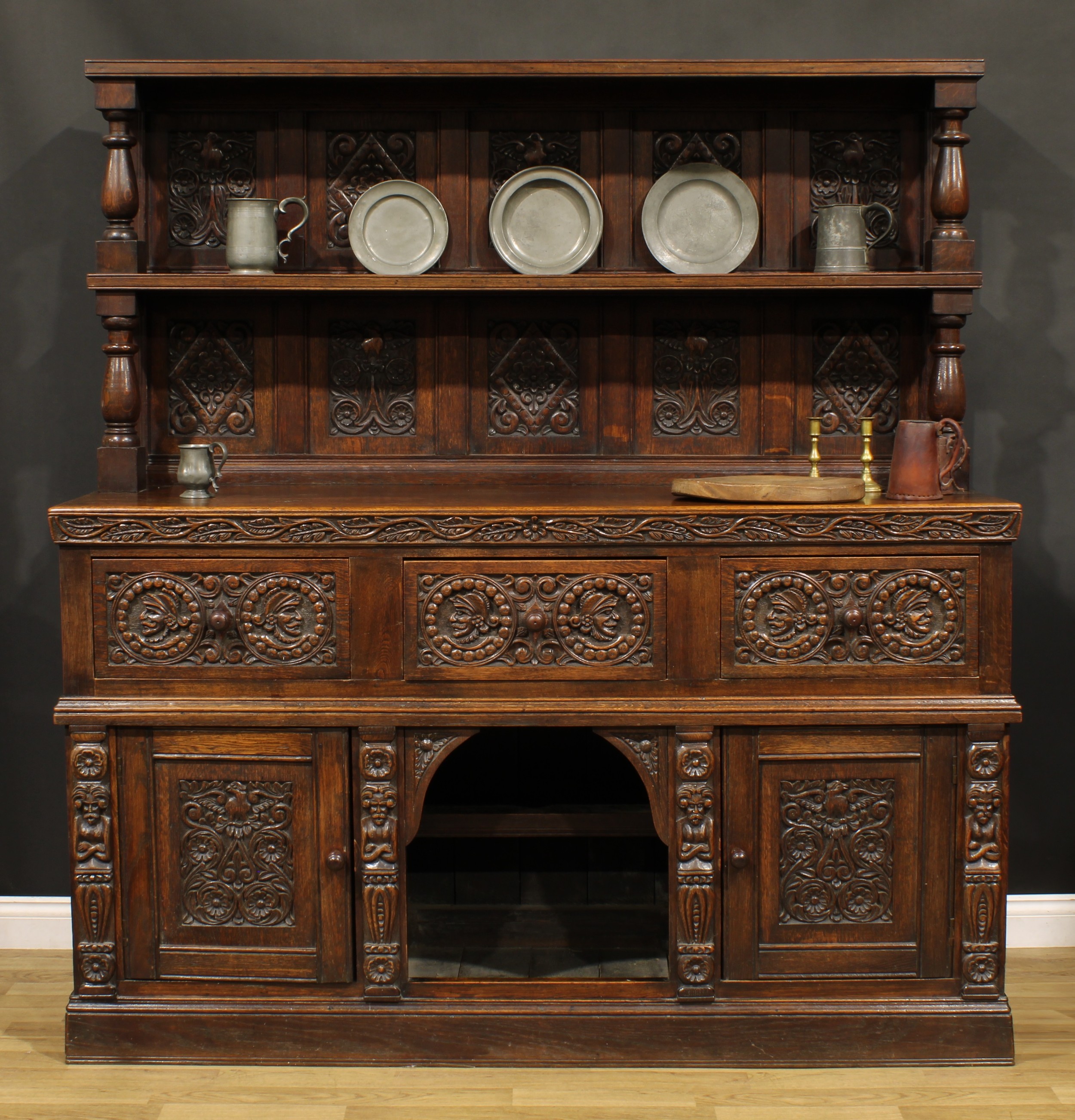 A 17th century style oak country house buffet side cabinet, panelled back with rectangular shelf,