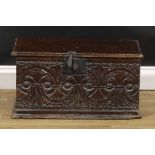 A 17th/early 18th century oak six-plank boarded table box, hinged cover, the front carved with