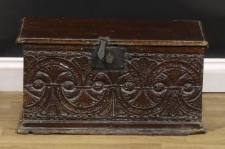 A 17th/early 18th century oak six-plank boarded table box, hinged cover, the front carved with