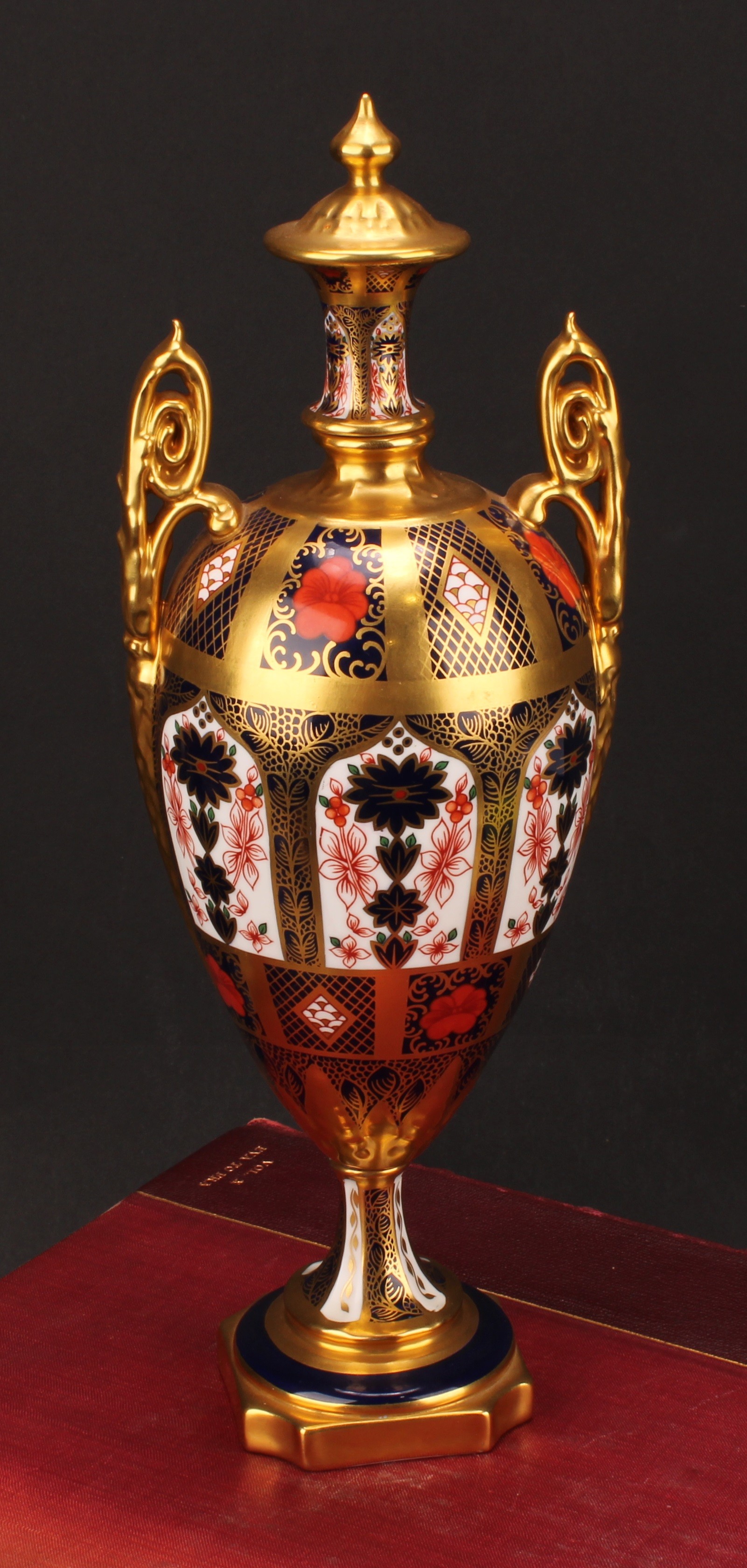 A Royal Crown Derby Imari 1128 pattern two handled pedestal vase and cover, solid gold band, first