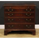A George III mahogany bachelor’s chest, rectangular top with moulded edge above a slide and four