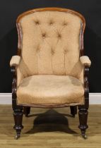 An early Victorian mahogany library chair, stuffed-over upholstery, scroll hand rests, turned