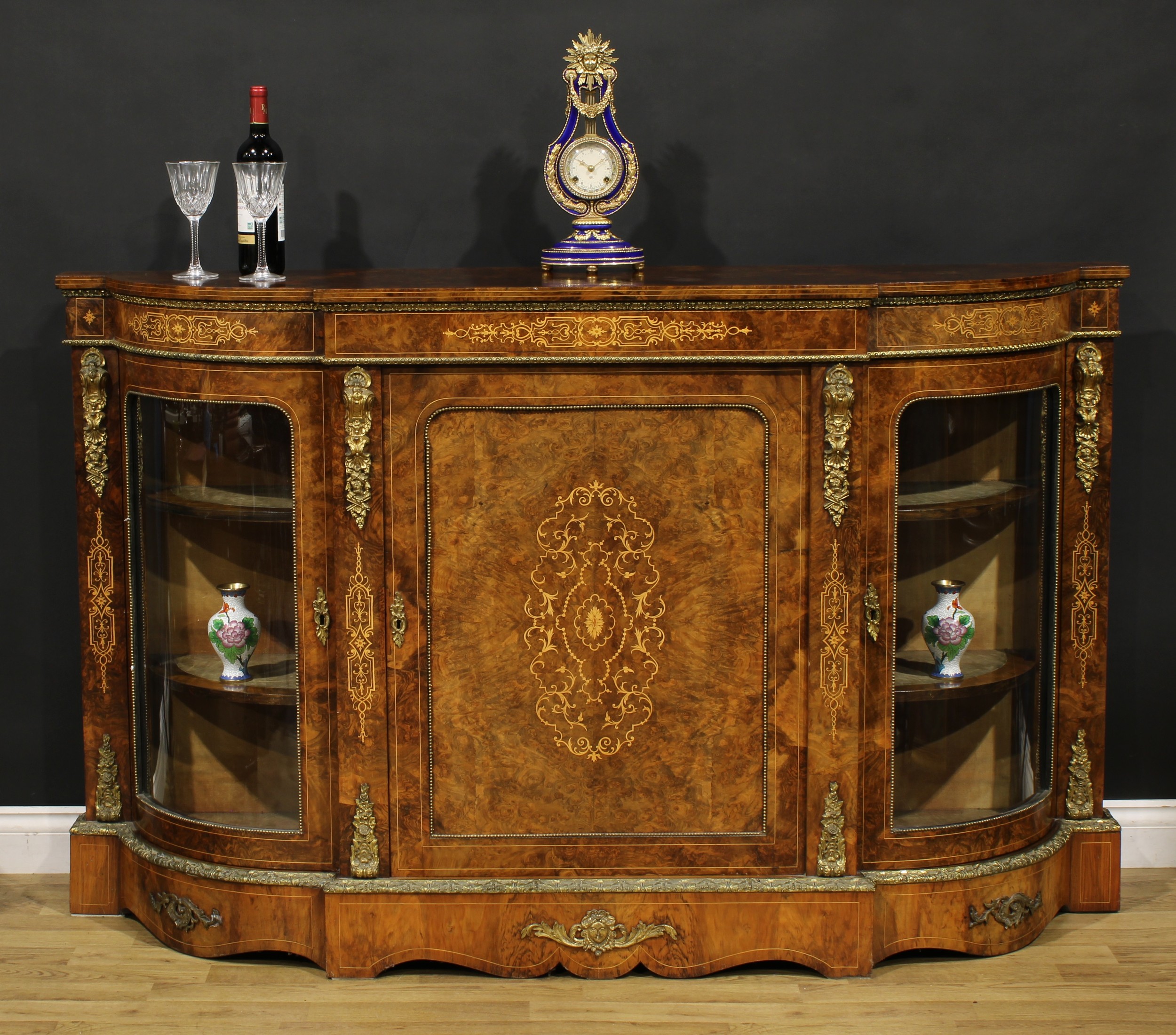 A Victorian gilt metal mounted walnut and marquetry credenza, slightly oversailing top above a panel