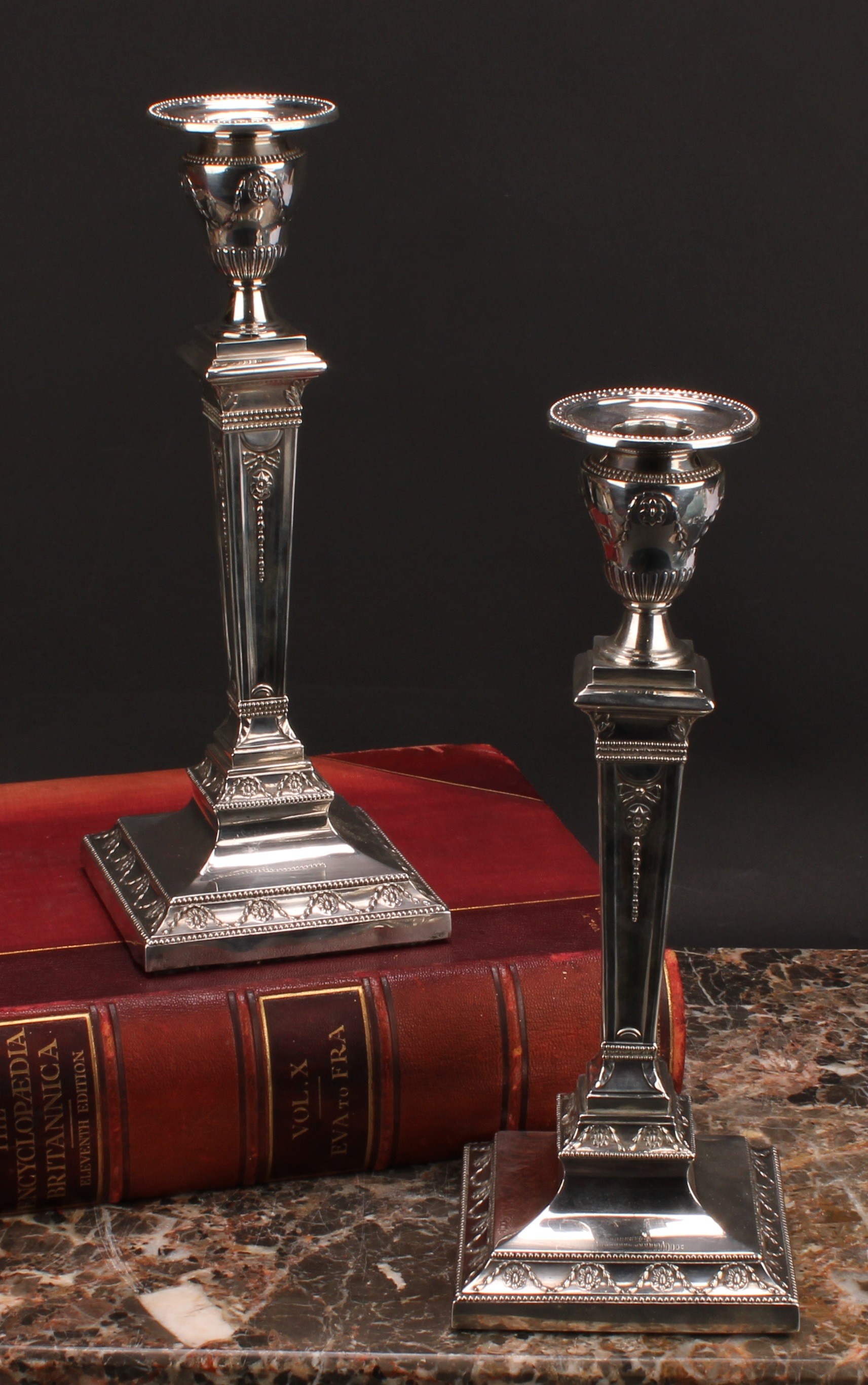 A pair of large Victorian Adam Revival square table candlesticks, embossed in the Neo-Classical