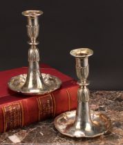 A pair of Swiss silver candlesticks, detachable nozzles, half-fluted sconces and socles, dished