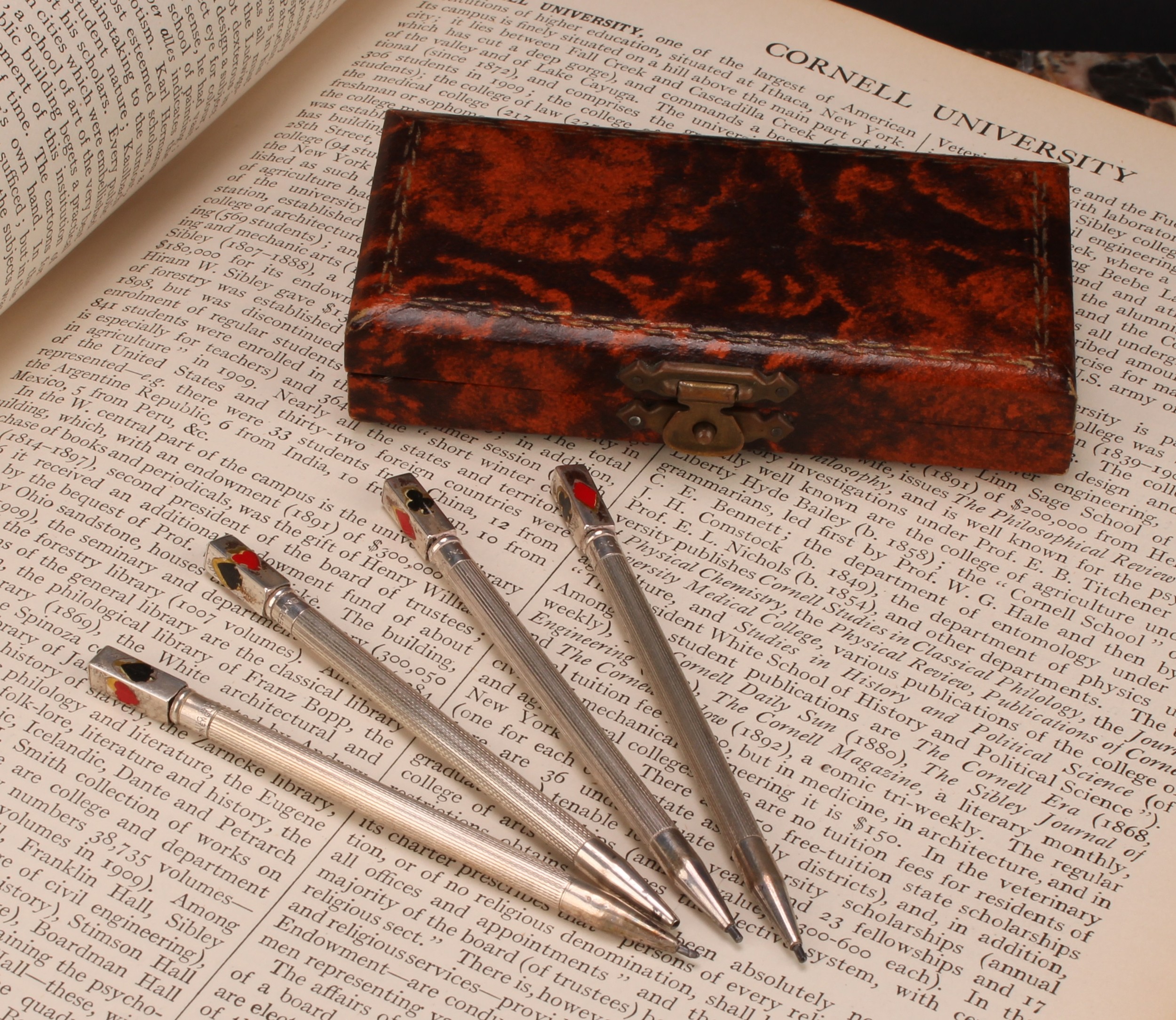A set of four sterling silver propelling pencils/bridge scoring markers, rectangular finials applied
