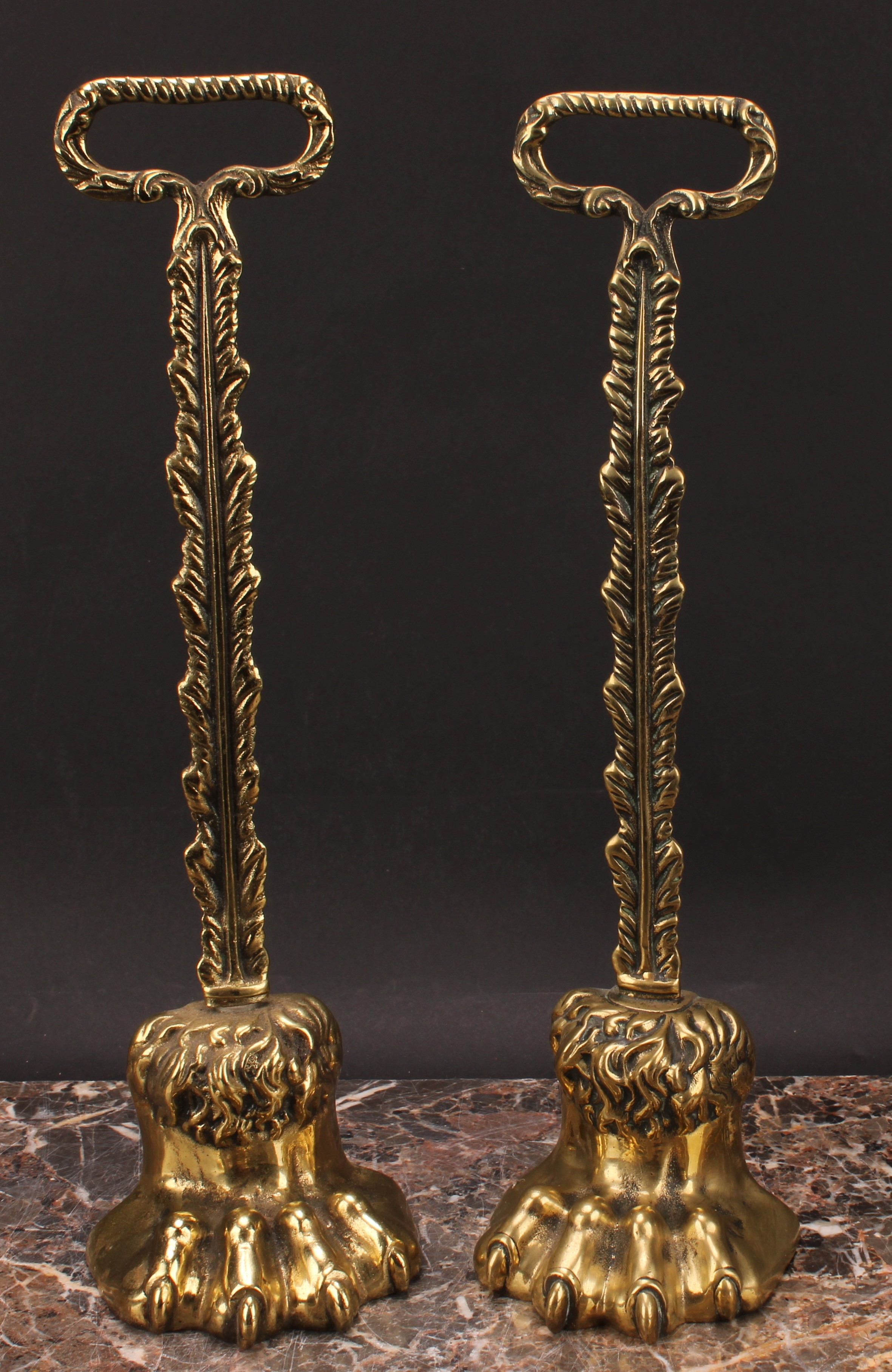 A pair of 19th century brass door stops, each cast as a lions paw, posted handles, lead-weighted - Image 2 of 3