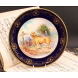 An Aynsley circular plate, painted by J. Shaw, signed to verso, with a Golden Retriever by a