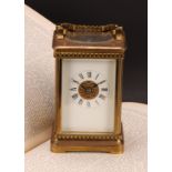 An early 20th century lacquered brass carriage clock, 6cm rectangular enamel dial inscribed with