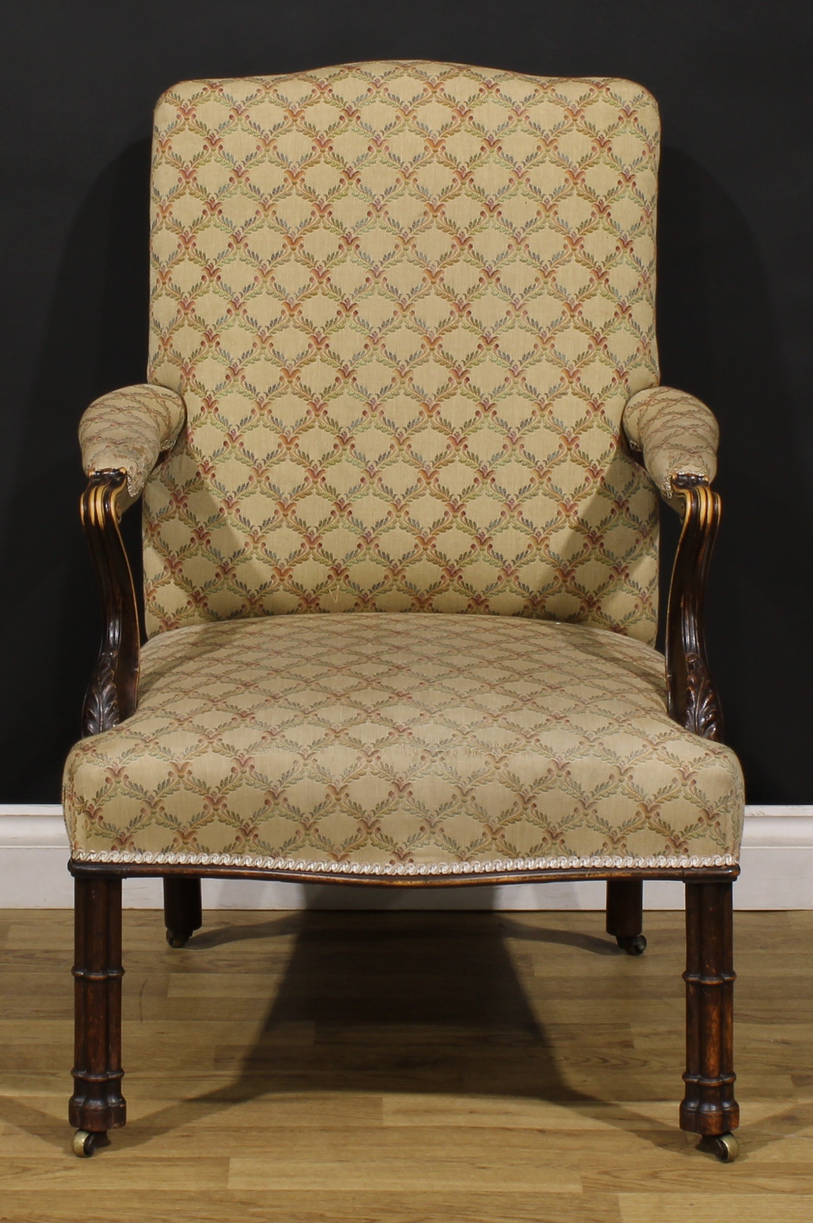 A 19th century French Hepplewhite Revival elbow chair, stuffed-over upholstery, scroll hand rests,