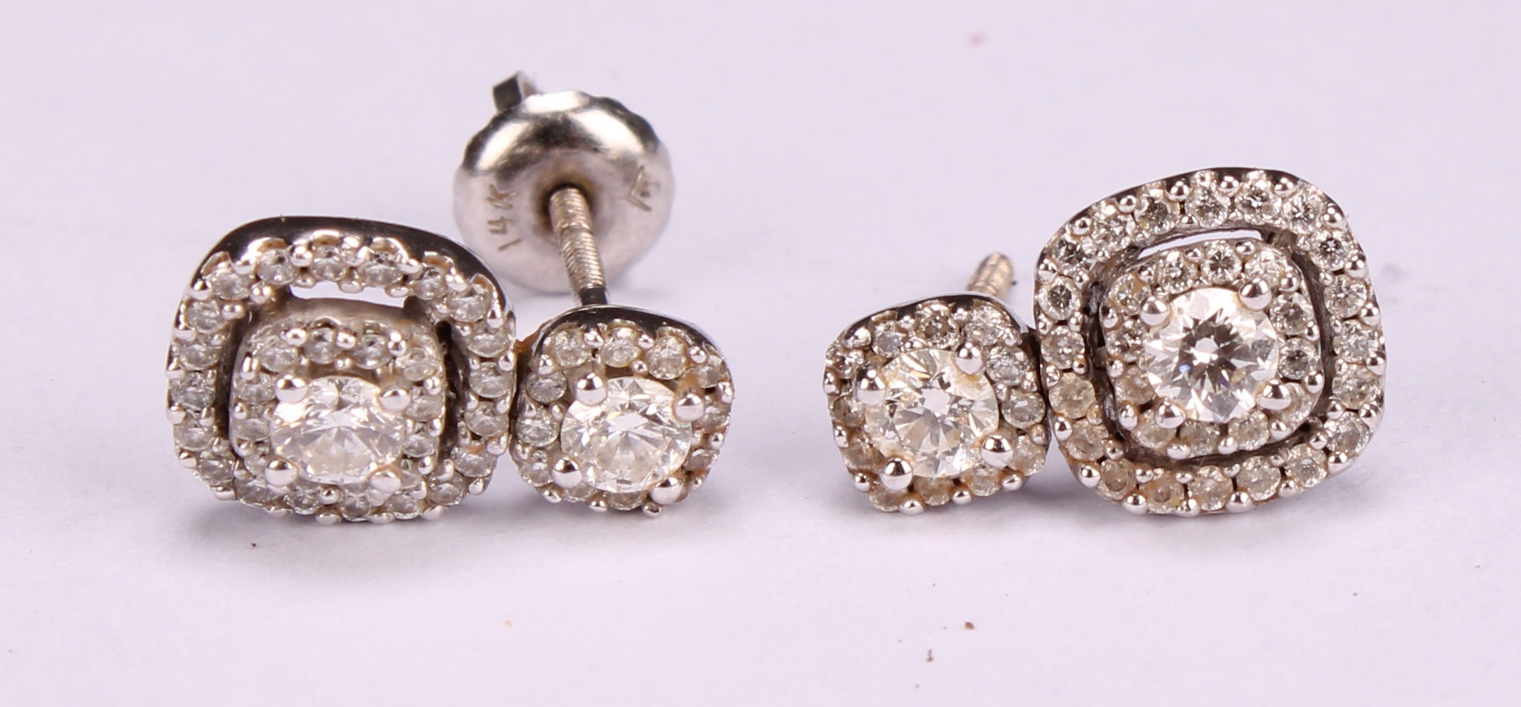 A pair diamond and 10ct white gold drop earrings, set in a halo arrangement of brilliant cut stones, - Image 4 of 4