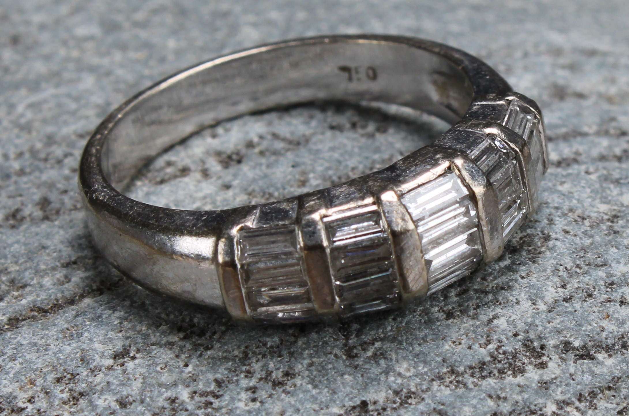 A diamond and 18ct white gold ring, with five bands of baguette cut stones, ring size M, 5.3g gross