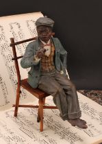 An early 20th century Austrian terracotta model, of a young African-American boy, finely dressed and