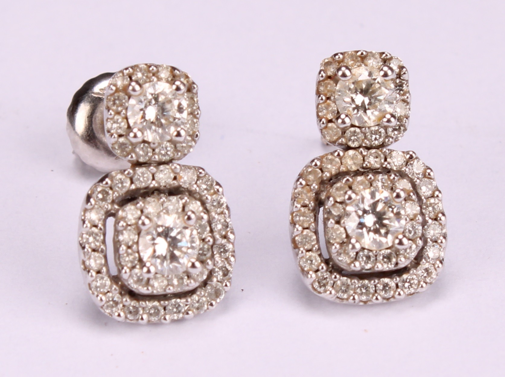 A pair diamond and 10ct white gold drop earrings, set in a halo arrangement of brilliant cut stones, - Image 2 of 4