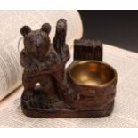 A Black Forest carved bear matchbox and vesta holder, brass liner, 11cm high
