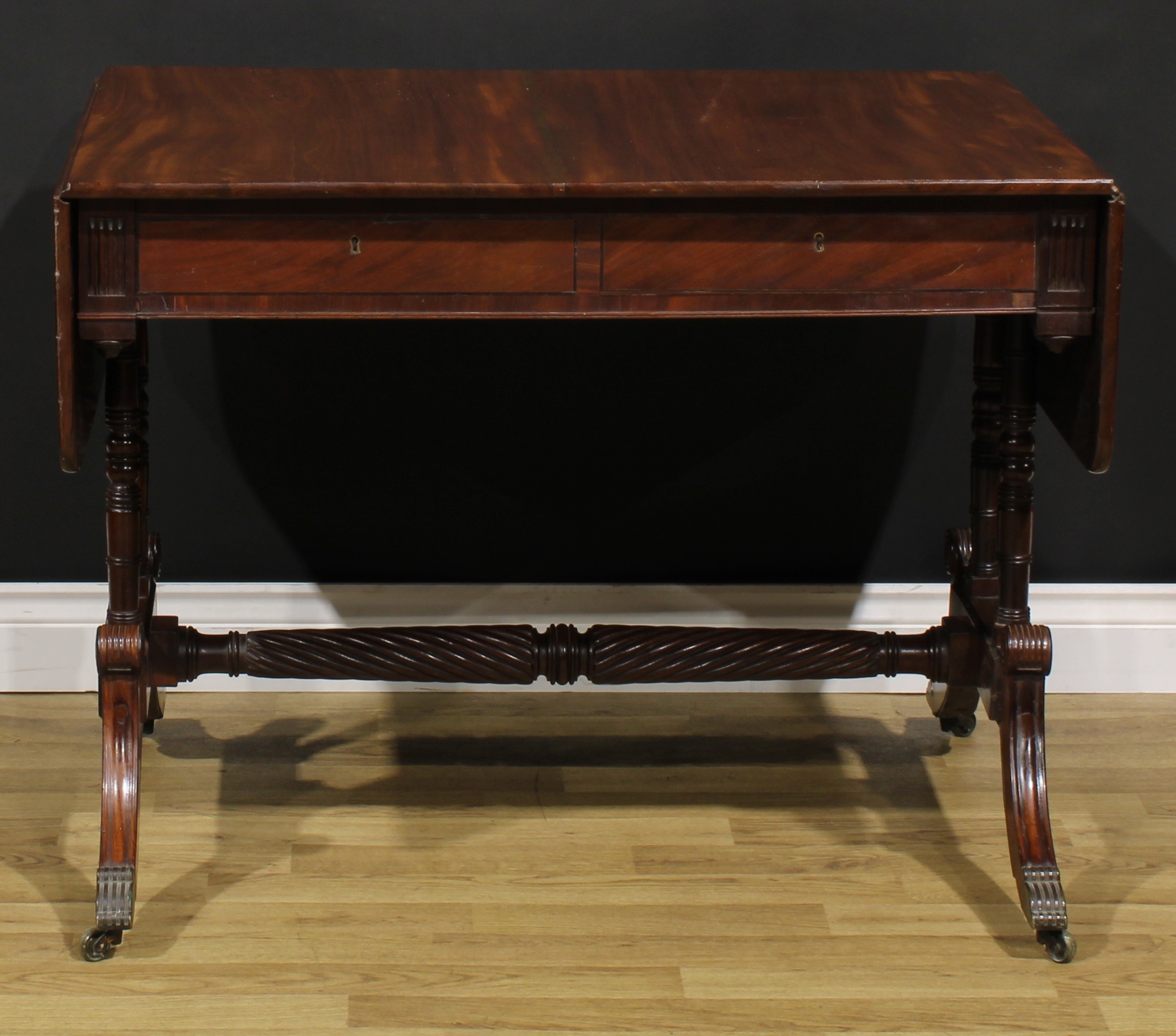 A Regency mahogany sofa table, possibly Irish, rounded rectangular top with fall leaves above a pair - Image 7 of 7