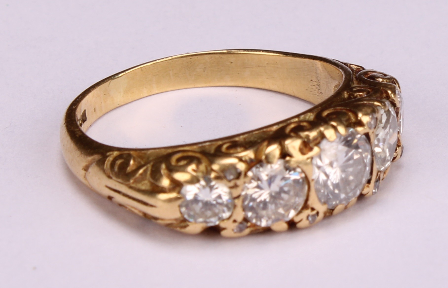 An 18ct gold five stone diamond ring, the graduated stones interspersed with diamond chips, - Image 2 of 4
