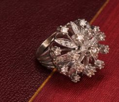 A large and impressive flowerhead diamond cluster ring, the central round brilliant cut stone within