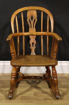 A 19th century ash and elm child’s Windsor rocking chair, pierced splat, 67cm high, 43cm wide