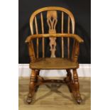 A 19th century ash and elm child’s Windsor rocking chair, pierced splat, 67cm high, 43cm wide