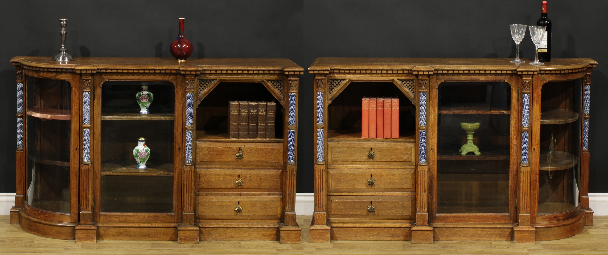 A pair of unusual Arts & Crafts period oak flanking credenzas, each with a slightly oversailing